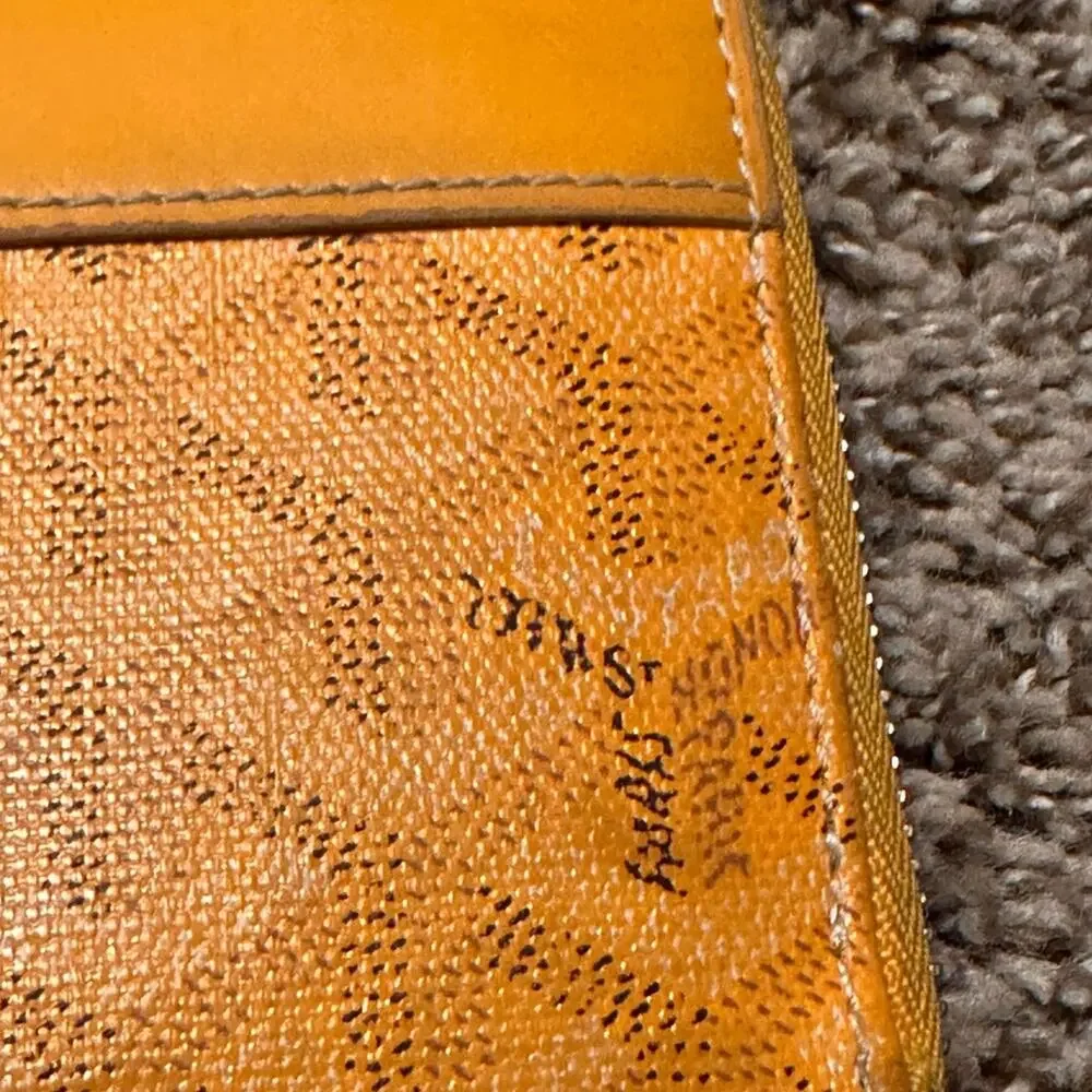 Goyard Matignon zip-around wallet in yellow orange Goyardine canvas.